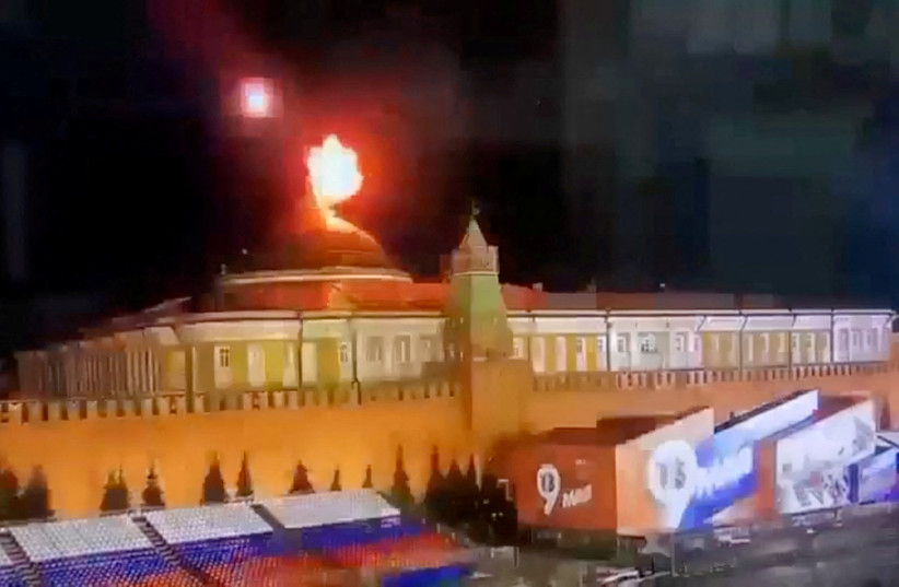  A still image taken from video shows a flying object exploding in an intense burst of light near the dome of the Kremlin Senate building during the alleged Ukrainian drone attack in Moscow, Russia, in this image taken from video obtained by Reuters May 3, 2023 (photo credit: OSTOROZHNO NOVOSTI/HANDOUT VIA REUTERS)