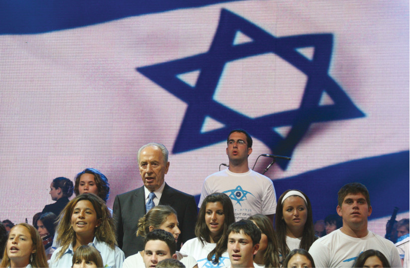  THEN-PRESIDENT Shimon Peres sings ‘Hatikva’ with Israeli youngsters, 2008. (photo credit: ANNA KAPLAN/FLASH90)