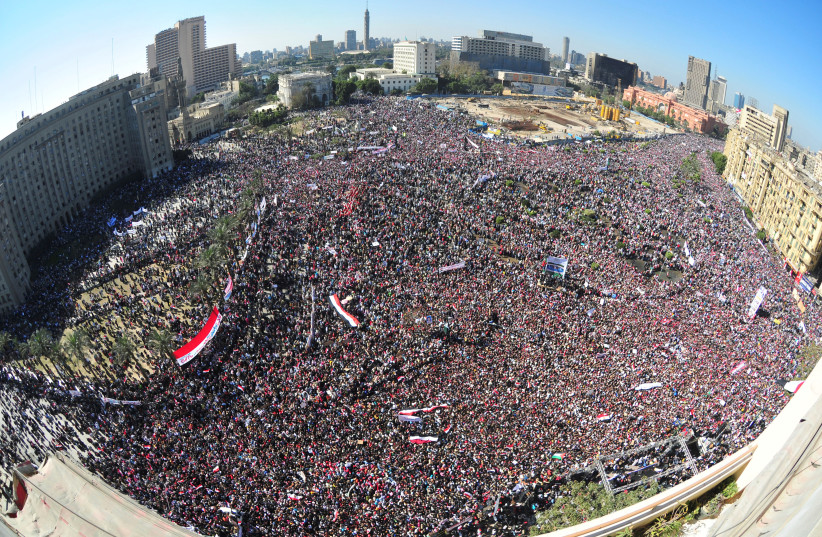 MODERN-DAY ‘coup’: Egyptian pro-democracy supporters gather in Cairo’s Tahrir Square in 2011, during the Arab Spring. (photo credit: Mohamed Abd El-Ghany/File/Reuters)