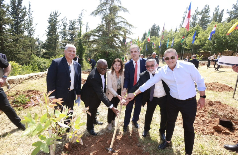  Zambia’s Ambassador to Israel Martin Mwanambale (second from left) plants a tree to celebrate Israel’s 75th, along with KKL-JNF representatives and Foreign Minister Eli Cohen (third from right.)  (photo credit: KKL-JNF)