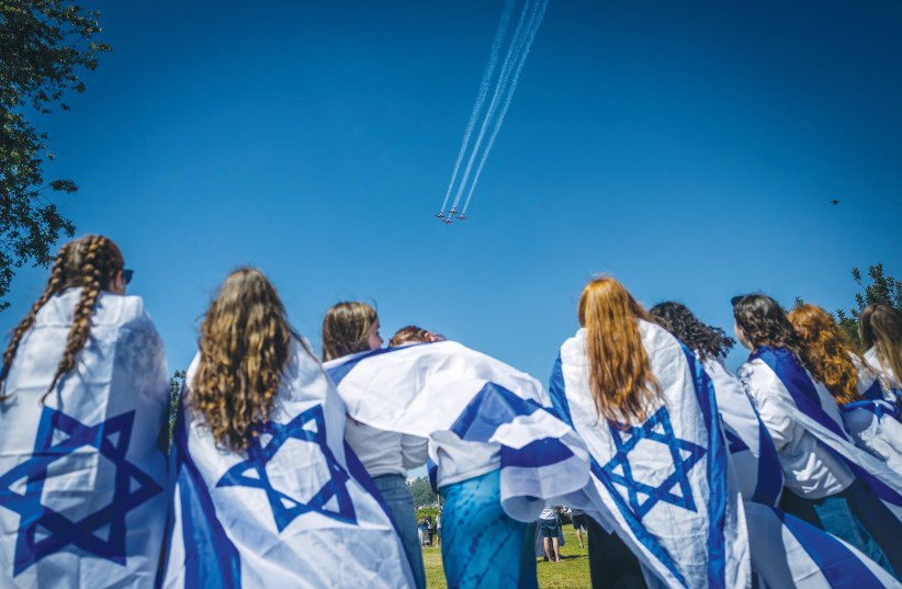  FLAG-ADORNED spectators watch the air show in the skies of Jerusalem on Independence Day. (photo credit: YONATAN SINDEL/FLASH 90)