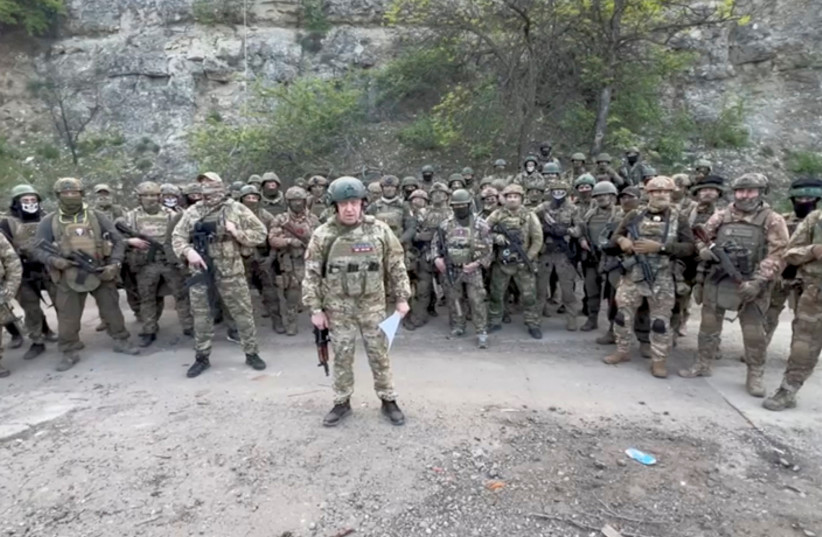  Founder of Wagner private mercenary group Yevgeny Prigozhin makes a statement as he stand next to Wagner fighters in an undisclosed location in the course of Russia-Ukraine conflict, in this still image taken from video released May 5, 2023 (photo credit: PRESS SERVICE OF "CONCORD"/HANDOUT VIA REUTERS)