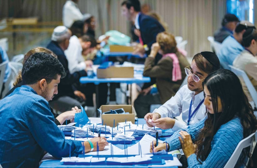 CENTRAL ELECTIONS Committee workers count ballots at the Knesset, after November’s election. Vote-counting proceeds efficiently and reliably, and the public perceives the results as legitimate.