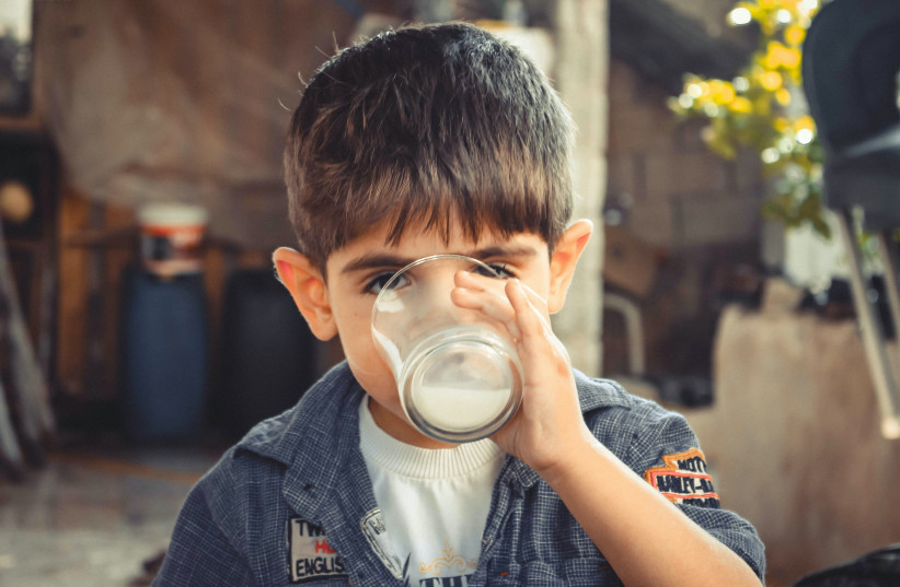  Illustrative image of a child drinking milk. (credit: PEXELS)