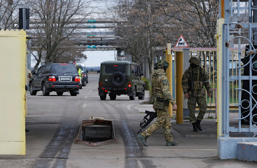  Russian service members guard the entrance to the Zaporizhzhia Nuclear Power Plant during a visit of the International Atomic Energy Agency (IAEA) expert mission in the course of Russia-Ukraine conflict outside Enerhodar in the Zaporizhzhia region, Russian-controlled Ukraine, March 29, 2023 (photo credit: REUTERS/ALEXANDER ERMOCHENKO)