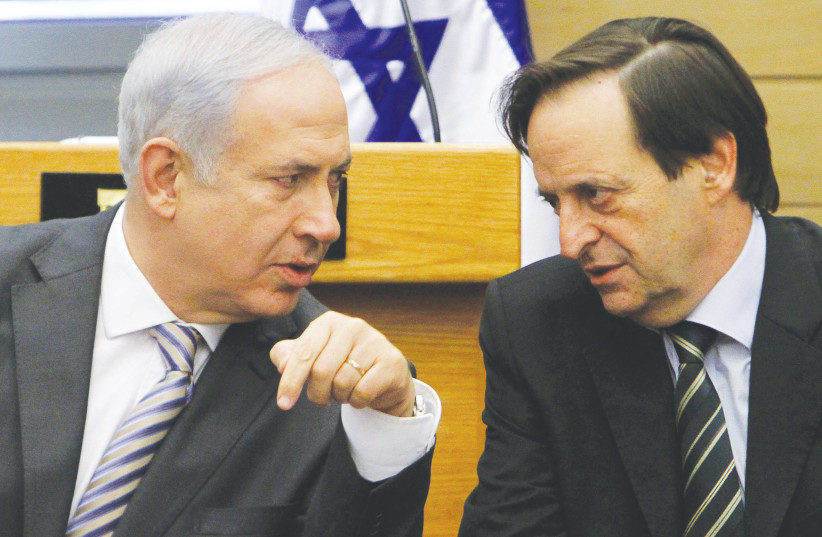  PRIME MINISTER Benjamin Netanyahu confers with then-cabinet minister Dan Meridor at a Likud meeting in the Knesset, in 2011. (photo credit: MIRIAM ALSTER/FLASH90)