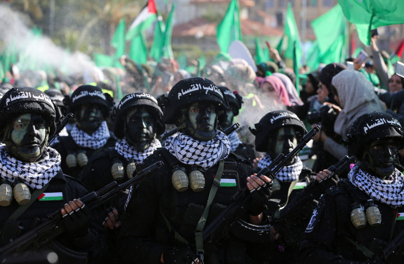  Members of Qassam Brigades choir attend a rally marking the 35th anniversary of the Hamas movement's founding, in Gaza City December 14, 2022.  (credit: IBRAHEEM ABU MUSTAFA/REUTERS)