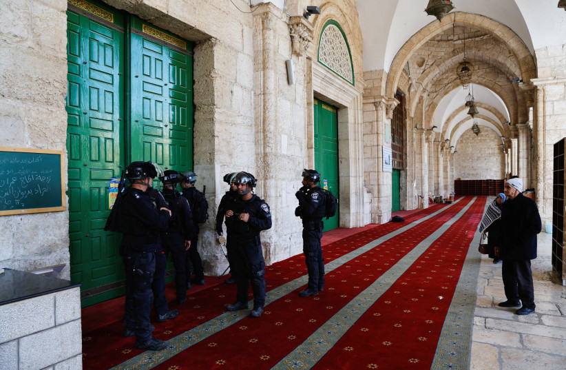  Israeli Border Police work at al-Aqsa mosque, also known to Jews as the Temple Mount, while tension arises during clashes with Palestinians in Jerusalem's Old City, April 5, 2023. (photo credit: AMMAR AWAD/REUTERS)