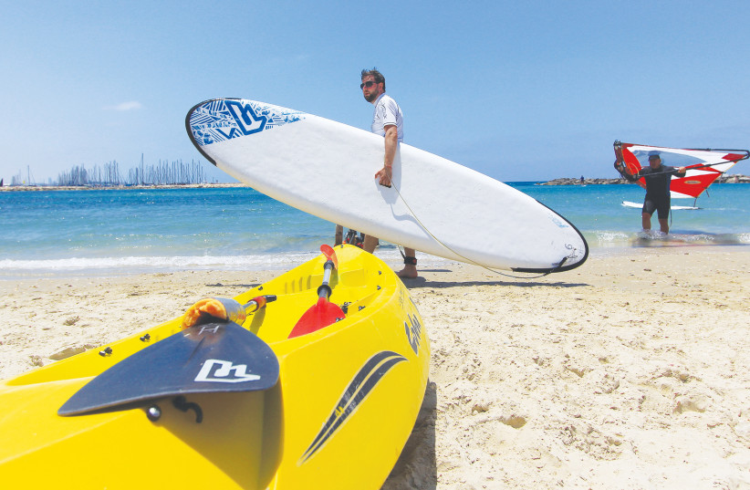  GOING WINDSURFING in Tel Aviv: The busy days at beaches and marinas are Friday and Shabbat, depriving those who are religiously observant of these experiences (Illustrative). (photo credit: Matt Hechter/Flash90)