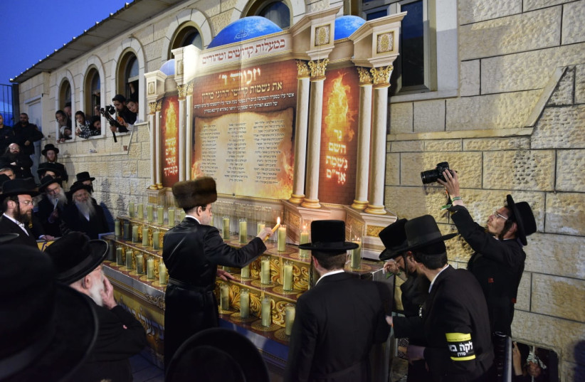 The Admor of Boyan lighting candles in memory of the 45 victims of Mount Meron, on the roof of the tomb of Rabbi Shimon Bar Yochai in Meron. (credit: Eli Segal)