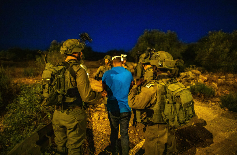 Golani Brigade soldiers during a nighttime operation to arrest Palestinians with illegal weapons in a West Bank village, on August 29, 2021. (photo credit: OLIVIER FITOUSSI/FLASH90)