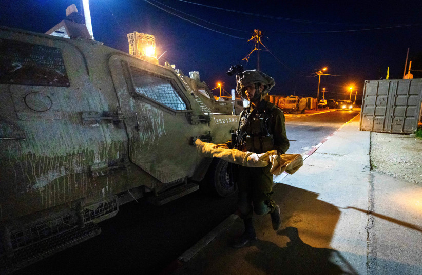  Golani Brigade soldiers during a nighttime operation to arrest Palestinians with illegal weapons in a West Bank village, on August 29, 2021. (credit: OLIVIER FITOUSSI/FLASH90)