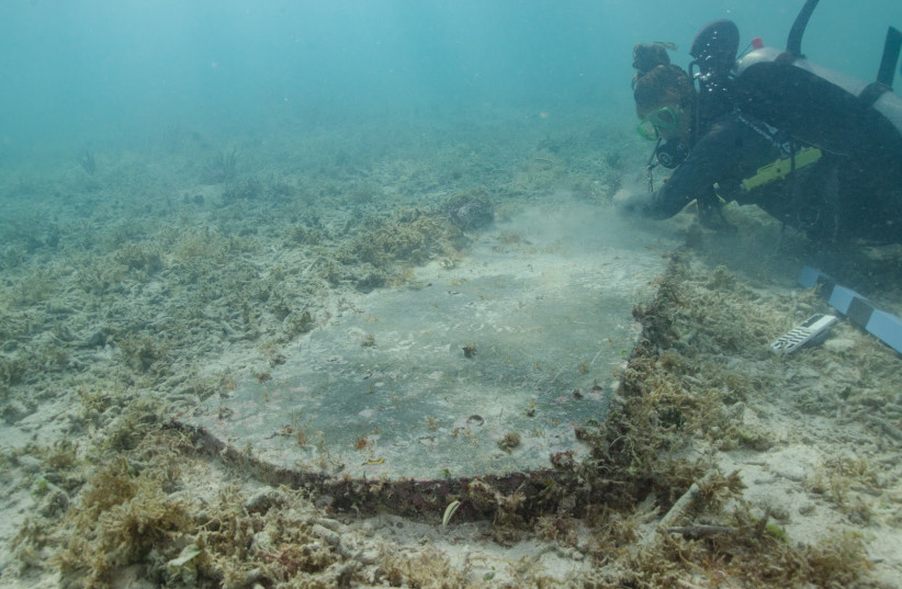 University of Miami graduate student Devon Fogarty examines the headstone of John Greer who died while working at Fort Jefferson on Nov. 5, 1861. The gravesite is now completely underwater. (credit: Image courtesy of the National Park Service)