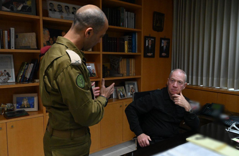  Defense Minister Yoav Gallant speaks with an IDF official at the start of Operation Shield and Arrow, May 9, 2023. (photo credit: ARIEL HERMONI/DEFENSE MINISTRY)