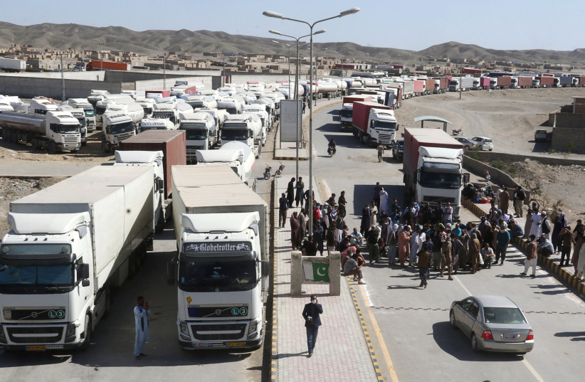  Trucks wait to cross into Iran, after Pakistan sealed its border with Iran as a preventive measure following the coronavirus outbreak, at the border post in Taftan, Pakistan February 25, 2020 (credit: REUTERS)