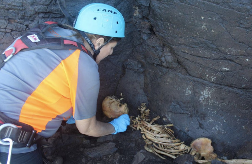  Archaeologist Veronica Alberto from Tibicena, an archaeology company, works on the extraction of human remains, in Galdar, on the island of Gran Canaria, Spain March 21, 2023 (photo credit:  Tibicena Arqueologia y Patrimonio S.L./Handout via REUTERS)