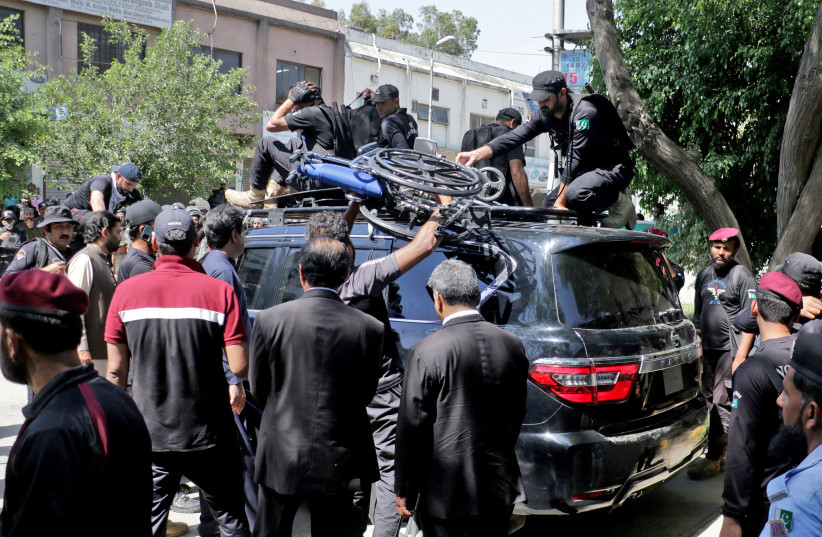  Pakistan security forces guard a vehicle carrying former Prime Minister Imran Khan after his arrest at a court in Islamabad, Pakistan, May 9, 2023 (photo credit: REUTERS/STRINGER)