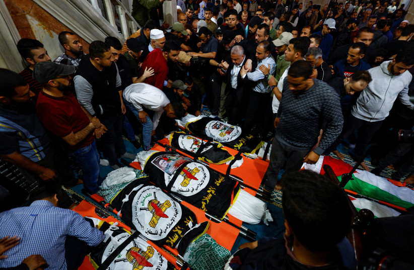  Mourners gather around the bodies of senior Palestinian Islamic Jihad commanders Tareq Izzeldeen and Khalil Al-Bahtini, and other Palestinians who were killed in Israeli strikes, during their funeral in Gaza City, May 9, 2023.  (credit: MOHAMMED SALEM/REUTERS)