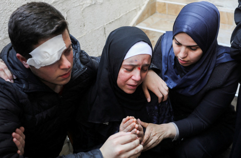 The wife and son of senior Palestinian Islamic Jihad commander Tareq Izzeldeen, who was killed in Israeli strike along with two of his children, react during his funeral in Gaza City, May 9, 2023. (credit: Ashraf Amra/Reuters)