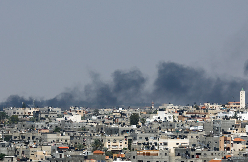  Smoke rises following an Israeli strike, in Khan Yunis in the southern Gaza Strip May 9, 2023. (credit: IBRAHEEM ABU MUSTAFA/REUTERS)