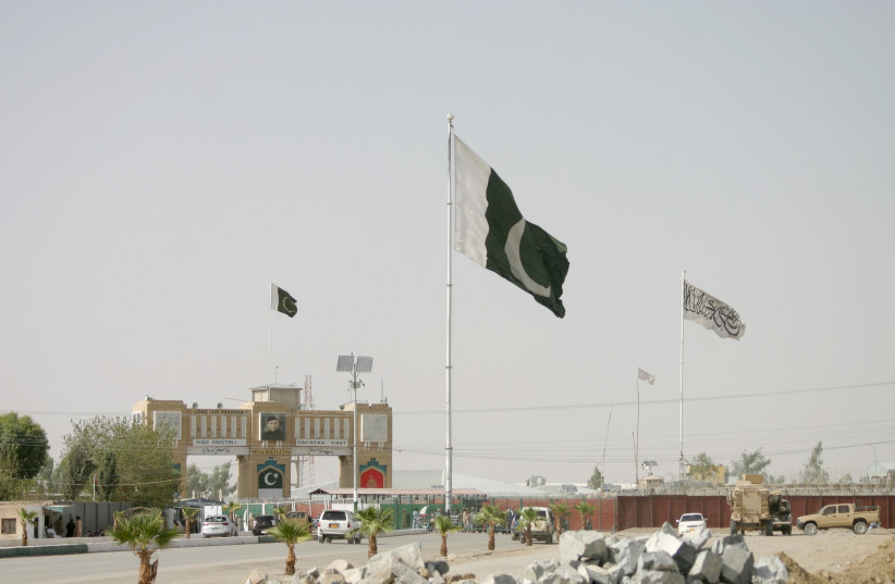 General view of Pakistan and Taliban flags at the Friendship Gate crossing point in the Pakistan-Afghanistan border town of Chaman, Pakistan August 27, 2021. (credit: REUTERS/SAEED ALI ACHAKZAI)