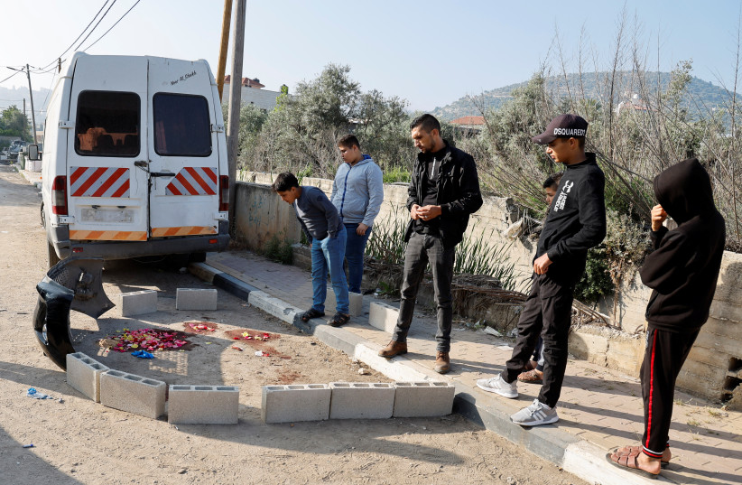  People stand near the site where two Palestinians were killed in an Israeli raid in Kabatiya, near Jenin, in the West Bank May 10, 2023. (photo credit: RANEEN SAWAFTA/REUTERS)