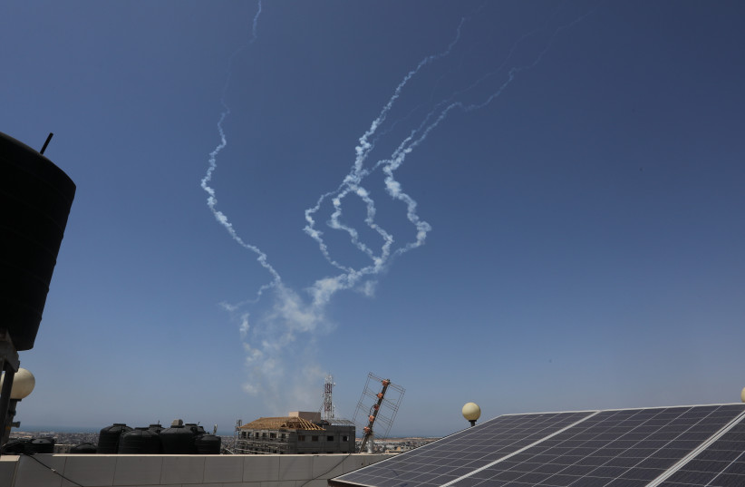 Trails of smoke are seen as rockets are fired from Gaza towards Israel, in the southern Gaza Strip, on May 10, 2023. (photo credit: ABED RAHIM KHATIB/FLASH90)