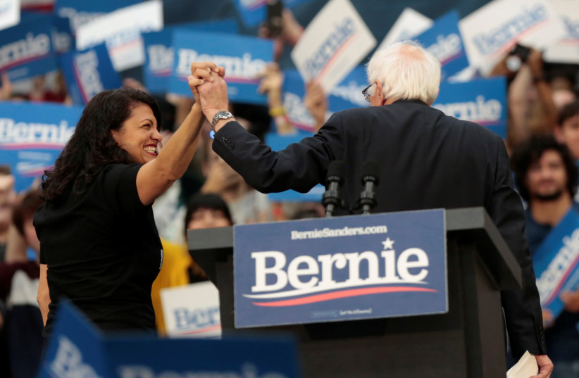  US Rep Rashida Tlaib and Democratic 2020 US presidential candidate Senator Bernie Sanders exit the stage following a campaign rally for Sanders in Detroit, Michigan, US October 27, 2019 (photo credit: REUTERS/REBECCA COOK)