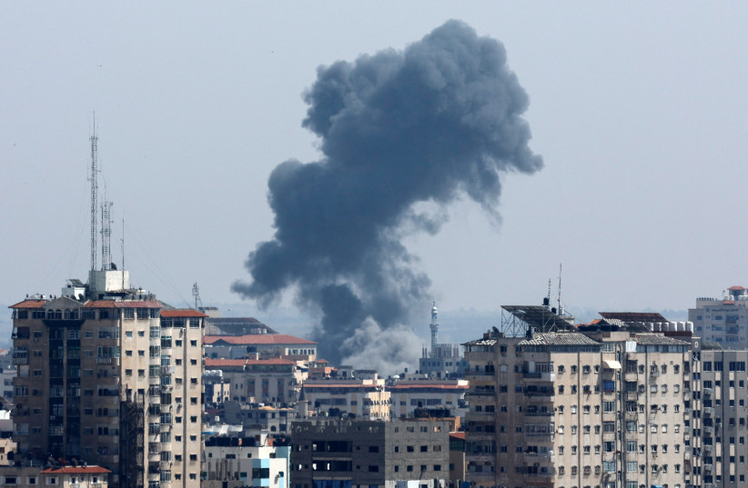  Smoke rises following an Israeli strike, in Gaza May 11, 2023.  (photo credit: MOHAMMED SALEM/REUTERS)