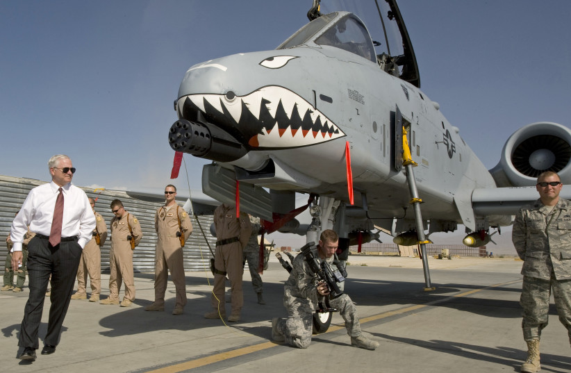  US Secretary of Defense Robert Gates (L) greets the crew and looks over an A-10 "Warthog", a close support aircraft, during an unannounced visit to Bagram Airfield September 17, 2008. (photo credit: REUTERS/Paul J. Richards/Pool)