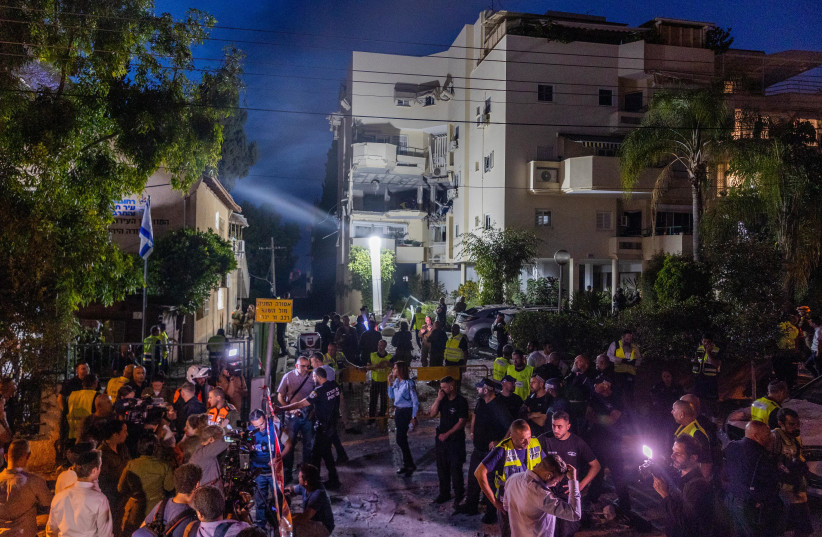  Police and rescue forces at the scene where a rocket fired from Gaza hit and damaged a house in Rehovot on May 11, 2023 (credit: YOSSI ALONI/FLASH90)