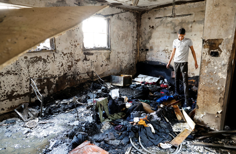  A man stands in a damaged building at the site of deadly Israeli raid in Balata camp in the West Bank May 13, 2023. (photo credit: REUTERS/RANEEN SAWAFTA)