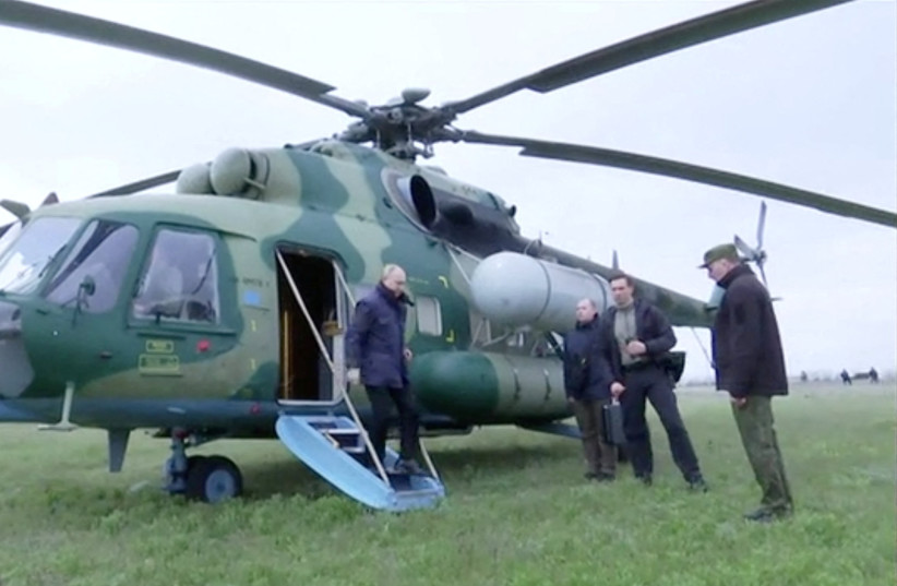 Russian President Vladimir Putin disembarks a helicopter as he visits the headquarters of the ''Dnieper'' army group in the Kherson Region, Russian-controlled Ukraine, in this still image taken from handout video released on April 18, 2023. (credit: KREMLIN.RU/HANDOUT VIA REUTERS)