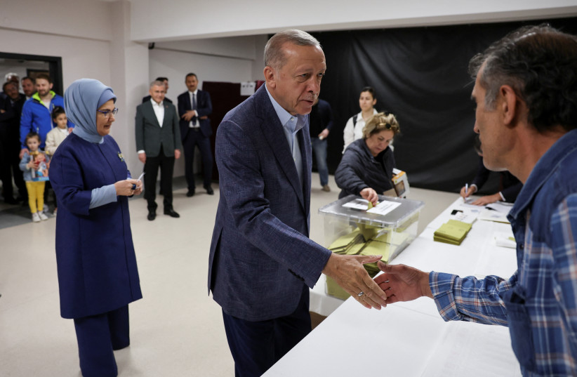  Turkish President Tayyip Erdogan greets a person at a polling station in Istanbul, Turkey May 14, 2023. (photo credit: REUTERS/Umit Bektas/Pool)