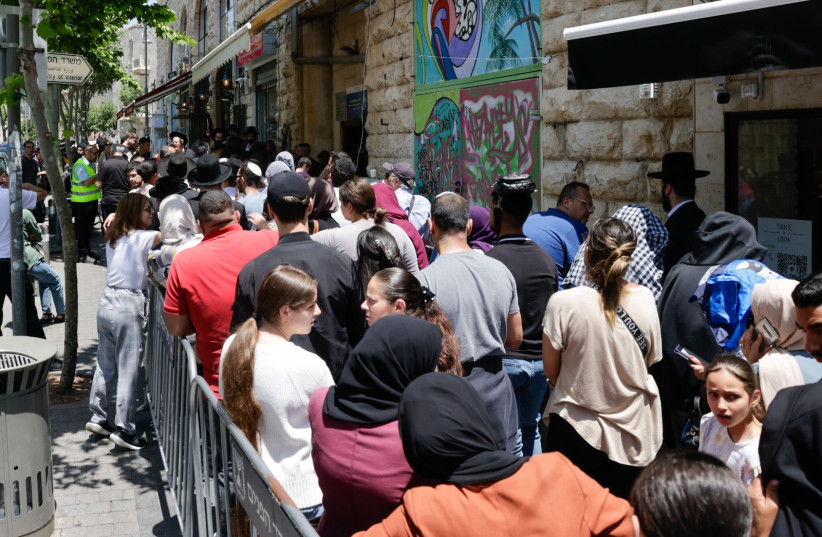  Major queues form at the Interior Ministry office in Jerusalem on the first day of appointment-free passport renewals. (credit: MARC ISRAEL SELLEM)