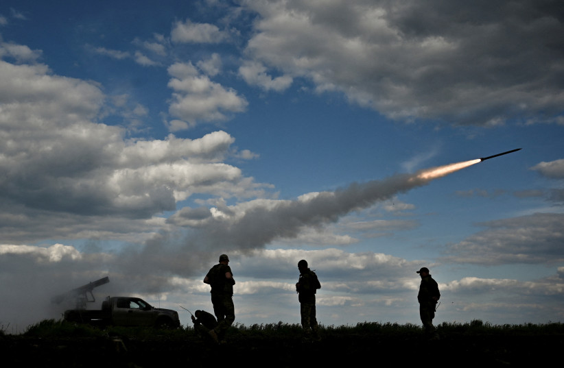 Ukrainian servicemen fire a Partyzan multiple launch rocket system towards Russian troops near a frontline, amid Russia's attack on Ukraine, in Zaporizhzhia region, Ukraine May 12, 2023. (photo credit: REUTERS/STRINGER)