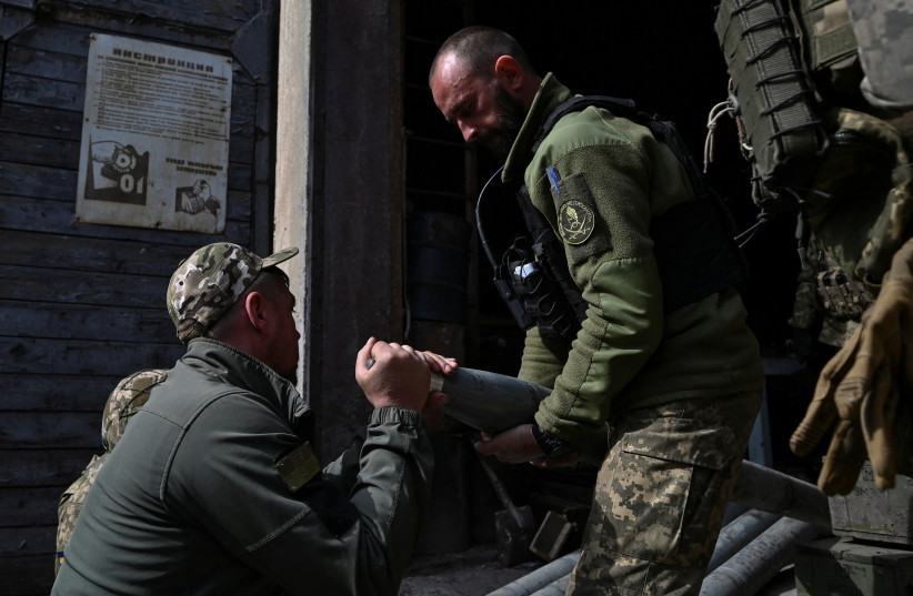  Ukrainian servicemen prepare MLRS shells near a frontline, amid Russia's attack on Ukraine, in Zaporizhzhia region, Ukraine May 12, 2023. (credit: REUTERS/STRINGER)