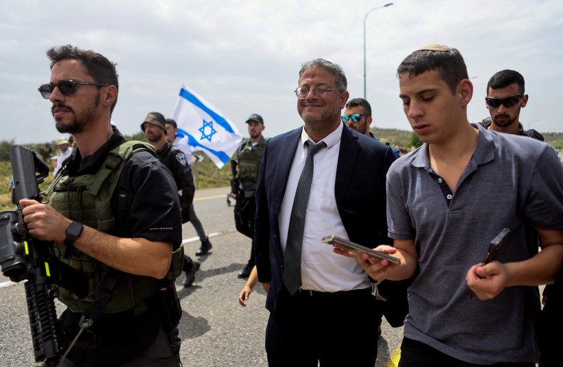  National Security Minister Itamar Ben-Gvir joins Israeli settlers as they hold a protest march from Tapuach Junction to the illegal outpost of Evyatar, in the West Bank, April 10, 2023 (photo credit: REUTERS/NIR ELIAS)