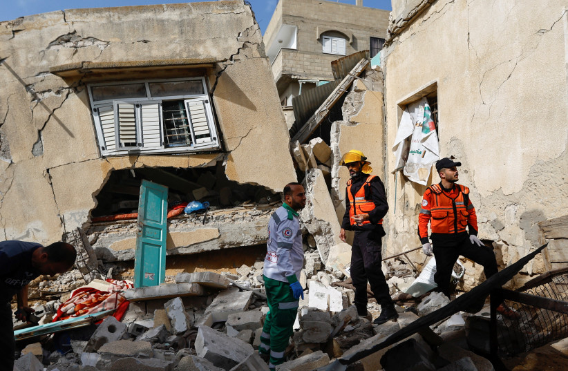  Palestinian rescue workers inspect a house where Islamic Jihad commander Ahmed Abu Daqqa was killed in an Israeli strike, in the southern Gaza Strip May 11, 2023 (credit: REUTERS/IBRAHEEM ABU MUSTAFA)