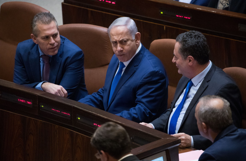 Prime Minister Benjamin Netanyahu (C) speaks with Public Security Minister Gilad Erdan (L), Culture and Sports Minister Miri Regev and Transportation Minister Israel Katz (R) seen during a Plenary Hall session for the vote on a bill to dissolve parliament, at the Knesset. (credit: YONATAN SINDEL/FLASH90)