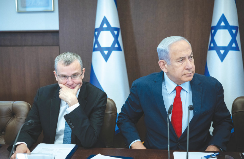  PRIME MINISTER Benjamin Netanyahu leads a cabinet meeting, in Jerusalem, last week, as Justice Minister Yariv Levin sits next to him.  (photo credit: YONATAN SINDEL/FLASH90)