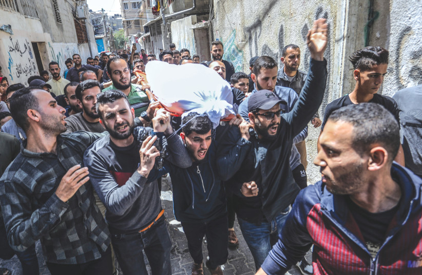  A FUNERAL procession takes place for Islamic Jihad commander Ali Ghali and his brother, Mahmoud, who were killed in an Israeli strike in Khan Yunis, Gaza Strip, on Thursday. (photo credit: ABED RAHIM KHATIB/FLASH90)
