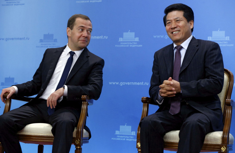  Li Hui, China's special representative for Eurasian affairs, (R) sat with Russian then-prime minister Dmitry Medvedev (L) during his time as ambassador to Moscow, on June 29, 2015. (photo credit: Dmitry Astakhov/RIA Novosti/Pool/Reuters)