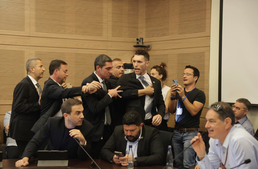  Yesh Atid MK Idan Roll is seen being forcibly removed from a Knesset committee at the orders of chairman Moshe Gafni during a debate on the City Tax Fund, in Jerusalem, on May 15, 2023. (photo credit: MARC ISRAEL SELLEM/THE JERUSALEM POST)