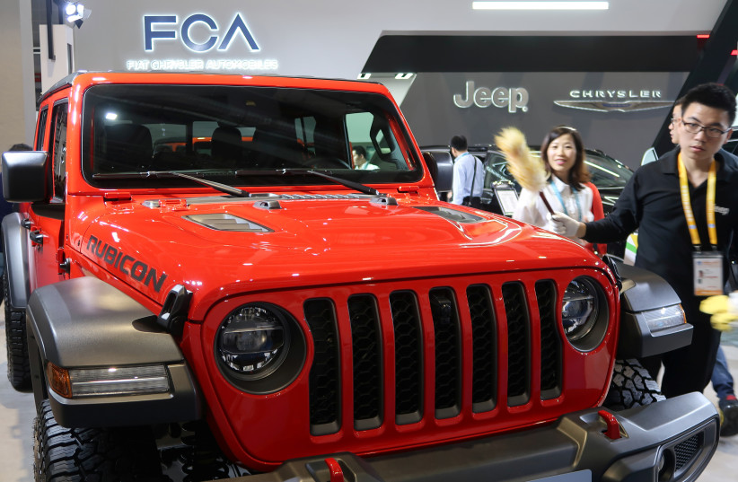 A staff member cleans a Jeep Gladiator pickup truck displayed at the Fiat Chrysler Automobiles (FCA) booth during the second China International Import Expo (CIIE) in Shanghai, China November 6, 2019. (photo credit: REUTERS/Yilei Sun/File Photo)