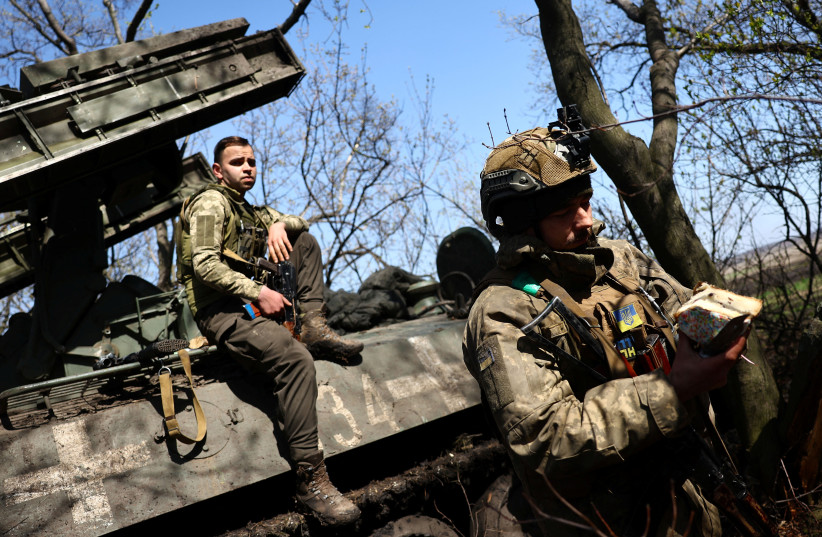  Vasilii (34), service man with Ukraine's 80th brigade eats some Easter cake in a forward position during heavy fighting amid Russia's attack on Ukraine, close to Bakhmut Ukraine, April 16, 2023.  (photo credit: REUTERS/KAI PFAFFENBACH)