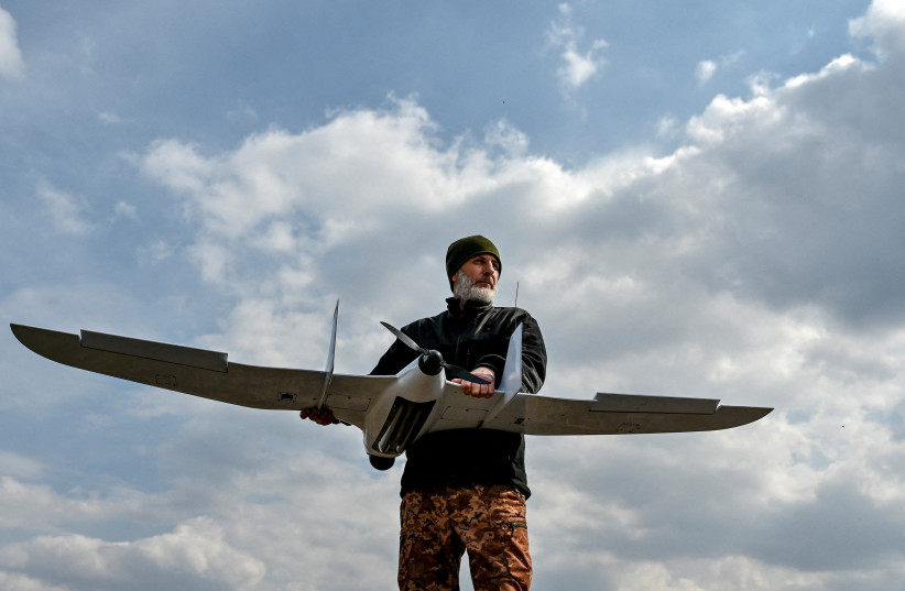  A Ukrainian serviceman holds an unmanned aerial vehicle at a position near a frontline, amid Russia's attack on Ukraine, in Zaporizhzhia region, Ukraine March 23, 2023. (credit: STRINGER/ REUTERS)