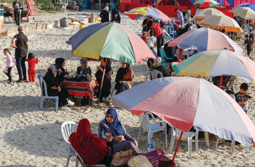  PALESTINIANS ENJOY the beach in Gaza City, on Sunday, after a ceasefire went into effect. With a little imagination, ingenuity and investment, Gaza could be turned into an enormously requested vacation spot.  (photo credit: ATIA MOHAMMED/FLASH90)