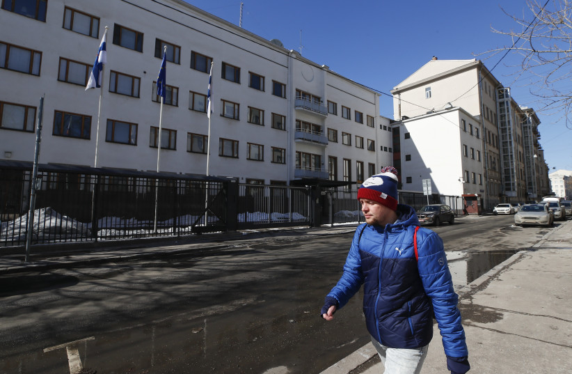  A man walks along a street near the embassy of Finland in Moscow, Russia March 29, 2018 (photo credit: REUTERS)