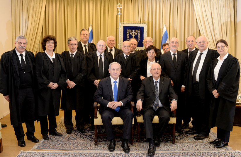  Then-president Reuven Rivlin and Prime Minister Benjamin Netanyahu pose for a group photo with Supreme Court justices in 2015. (photo credit: KOBI GIDEON/GPO)